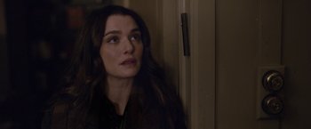 Movie still from “Disobedience” (2017), directed by Sebastián Lelio – A person with long brown hair; Close Up shot, Over the shoulder angle