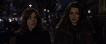 Movie still from “Disobedience” (2017), directed by Sebastián Lelio – Two women walking down a street at night; Close Up shot, Over the shoulder angle