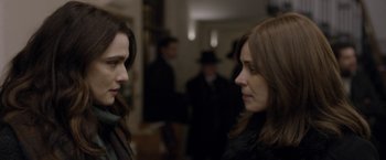 Movie still from “Disobedience” (2017), directed by Sebastián Lelio – Two women are standing in front of each other in a room; Close Up shot, Over the shoulder angle