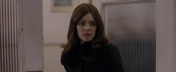 Movie still from “Disobedience” (2017), directed by Sebastián Lelio – A person wearing a coat; Close Up shot, Over the shoulder angle