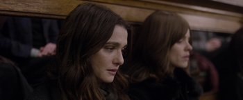 Movie still from “Disobedience” (2017), directed by Sebastián Lelio – A person with long brown hair; Close Up shot, Over the shoulder angle