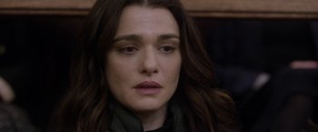 Movie still from “Disobedience” (2017), directed by Sebastián Lelio – A person with long brown hair; Close Up shot, Over the shoulder angle