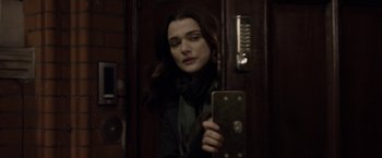 Movie still from “Disobedience” (2017), directed by Sebastián Lelio – A woman is looking at her cell phone in the dark; Close Up shot, Over the shoulder angle