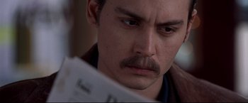 Movie still from “Donnie Brasco” (1997), directed by Mike Newell – A person looking at a paper; Close Up shot, High angle