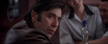 Movie still from “Donnie Brasco” (1997), directed by Mike Newell – A person wearing a brown jacket; Close Up shot, Over the shoulder angle