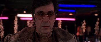 Movie still from “Donnie Brasco” (1997), directed by Mike Newell – A person wearing glasses and a fur coat; Close Up shot, Low angle