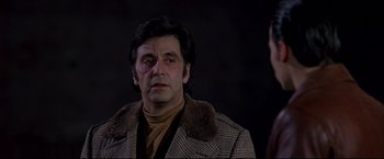 Movie still from “Donnie Brasco” (1997), directed by Mike Newell – A man wearing a coat and a tie; Close Up shot, Over the shoulder angle