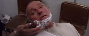 Movie still from “Donnie Brasco” (1997), directed by Mike Newell – An older man is shaving his face with a razor; Close Up shot, Low angle