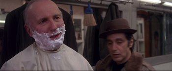 Movie still from “Donnie Brasco” (1997), directed by Mike Newell – A man with a shaving cream on his face and another man with a hat; Close Up shot, Over the shoulder angle