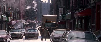 Movie still from “Donnie Brasco” (1997), directed by Mike Newell – Two people walking down the street in a busy city; Wide shot, Low angle