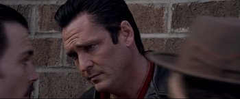 Movie still from “Donnie Brasco” (1997), directed by Mike Newell – A person wearing a leather jacket; Close Up shot, Over the shoulder angle
