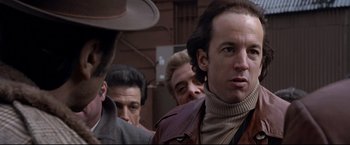 Movie still from “Donnie Brasco” (1997), directed by Mike Newell – A group of men standing next to each other on the street; Close Up shot, Low angle