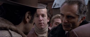 Movie still from “Donnie Brasco” (1997), directed by Mike Newell – A group of men standing next to each other on a street; Close Up shot, Over the shoulder angle