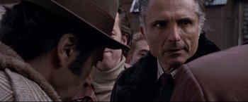 Movie still from “Donnie Brasco” (1997), directed by Mike Newell – A group of people standing next to each other in a room; Close Up shot, Over the shoulder angle