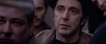 Movie still from “Donnie Brasco” (1997), directed by Mike Newell – A person wearing a hat and looking at the camera; Close Up shot, Over the shoulder angle