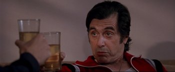 Movie still from “Donnie Brasco” (1997), directed by Mike Newell – A person holding a glass of water; Close Up shot, Low angle