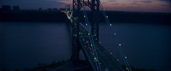 Movie still from “Donnie Brasco” (1997), directed by Mike Newell – A view of a suspension bridge at night with green lights; Extreme Wide shot, High angle