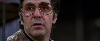 Movie still from “Donnie Brasco” (1997), directed by Mike Newell – A person wearing a pair of glasses; Close Up shot, Low angle