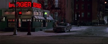 Movie still from “Donnie Brasco” (1997), directed by Mike Newell – A car parked in the middle of a street at night; Extreme Wide shot, High angle