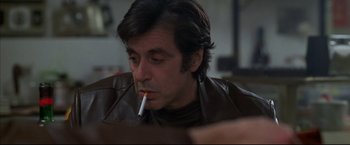 Movie still from “Donnie Brasco” (1997), directed by Mike Newell – A person with a cigarette in his mouth; Close Up shot, Over the shoulder angle