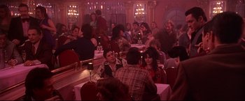 Movie still from “Donnie Brasco” (1997), directed by Mike Newell – A group of people sitting at a table in a restaurant; Wide shot, High angle
