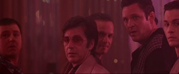 Movie still from “Donnie Brasco” (1997), directed by Mike Newell – A man in a suit standing next to another man in a suit; Medium shot, Low angle