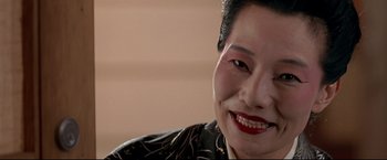 Movie still from “Donnie Brasco” (1997), directed by Mike Newell – A person with a smile on their face; Close Up shot, High angle