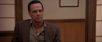 Movie still from “Donnie Brasco” (1997), directed by Mike Newell – A person wearing a suit and tie; Close Up shot, Low angle