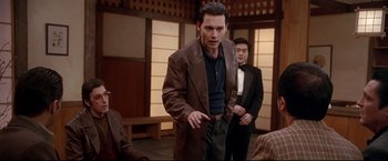 Movie still from “Donnie Brasco” (1997), directed by Mike Newell – A man in a brown jacket and a man in a black suit; Medium shot, Over the shoulder angle