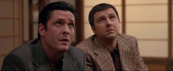 Movie still from “Donnie Brasco” (1997), directed by Mike Newell – A couple of men sitting next to each other in a room; Close Up shot, Low angle