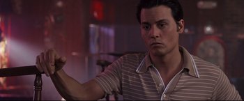 Movie still from “Donnie Brasco” (1997), directed by Mike Newell – A person holding something in his hand; Close Up shot, Low angle