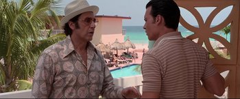 Movie still from “Donnie Brasco” (1997), directed by Mike Newell – A man and a woman talking in front of an ocean; Medium shot, Over the shoulder angle