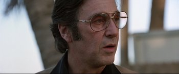 Movie still from “Donnie Brasco” (1997), directed by Mike Newell – A person wearing glasses; Close Up shot, Low angle