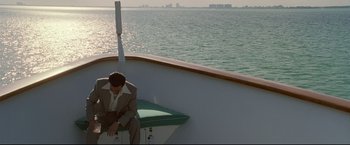 Movie still from “Donnie Brasco” (1997), directed by Mike Newell – A man sitting on the back end of a boat; Wide shot, High angle