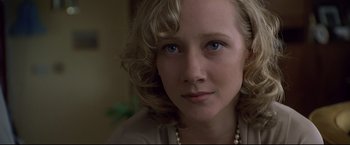 Movie still from “Donnie Brasco” (1997), directed by Mike Newell – A person wearing a pearl necklace; Close Up shot, Over the shoulder angle