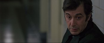 Movie still from “Donnie Brasco” (1997), directed by Mike Newell – A man's face in a dark room; Close Up shot, Over the shoulder angle