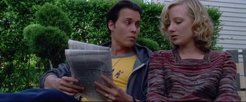 Movie still from “Donnie Brasco” (1997), directed by Mike Newell – A man and a woman are reading a newspaper together; Close Up shot, Low angle