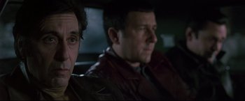 Movie still from “Donnie Brasco” (1997), directed by Mike Newell – Two men sitting next to each other in the back of a car; Close Up shot, Over the shoulder angle