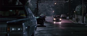 Movie still from “Donnie Brasco” (1997), directed by Mike Newell – Cars parked on the side of the road at night; Extreme Wide shot, High angle