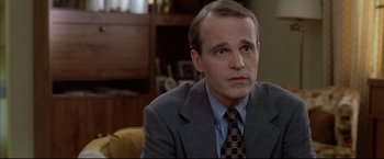 Movie still from “Donnie Brasco” (1997), directed by Mike Newell – A person wearing a suit and tie; Close Up shot, Over the shoulder angle