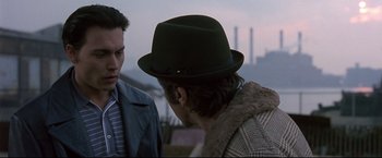 Movie still from “Donnie Brasco” (1997), directed by Mike Newell – A man wearing a green hat talking to another man; Close Up shot, Over the shoulder angle