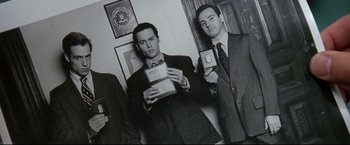 Movie still from “Donnie Brasco” (1997), directed by Mike Newell – A black and white photo of two men in suits and ties; Medium shot, Low angle