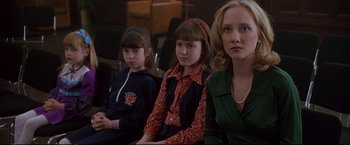 Movie still from “Donnie Brasco” (1997), directed by Mike Newell – A group of young girls sitting next to each other; Medium shot, Over the shoulder angle