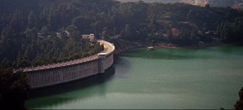 Movie still from “Earthquake” (1974), directed by Mark Robson – A view of a lake with a bridge going over it; Extreme Wide shot, High angle