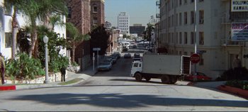 Movie still from “Earthquake” (1974), directed by Mark Robson – A truck driving down a street next to tall buildings; Extreme Wide shot, High angle
