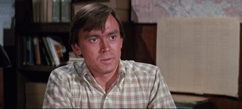 Movie still from “Earthquake” (1974), directed by Mark Robson – A person wearing a plaid shirt; Close Up shot, High angle