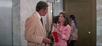 Movie still from “Earthquake” (1974), directed by Mark Robson – A man and a woman talking to each other; Medium shot, Over the shoulder angle