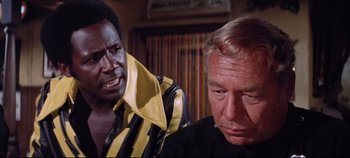 Movie still from “Earthquake” (1974), directed by Mark Robson – A man and a woman are looking at each other; Close Up shot, Over the shoulder angle