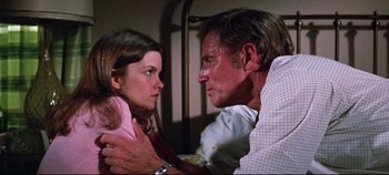 Movie still from “Earthquake” (1974), directed by Mark Robson – A man and a woman looking into each others eyes; Close Up shot, Low angle