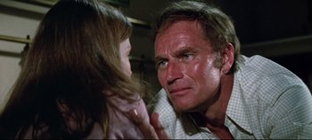 Movie still from “Earthquake” (1974), directed by Mark Robson – A man and a little girl looking at each other; Close Up shot, Over the shoulder angle